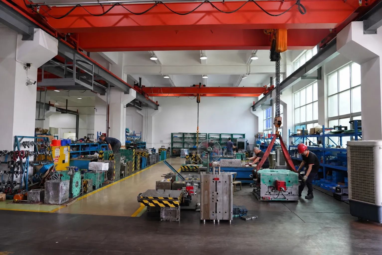 Technicians fitting and assembling injection molds